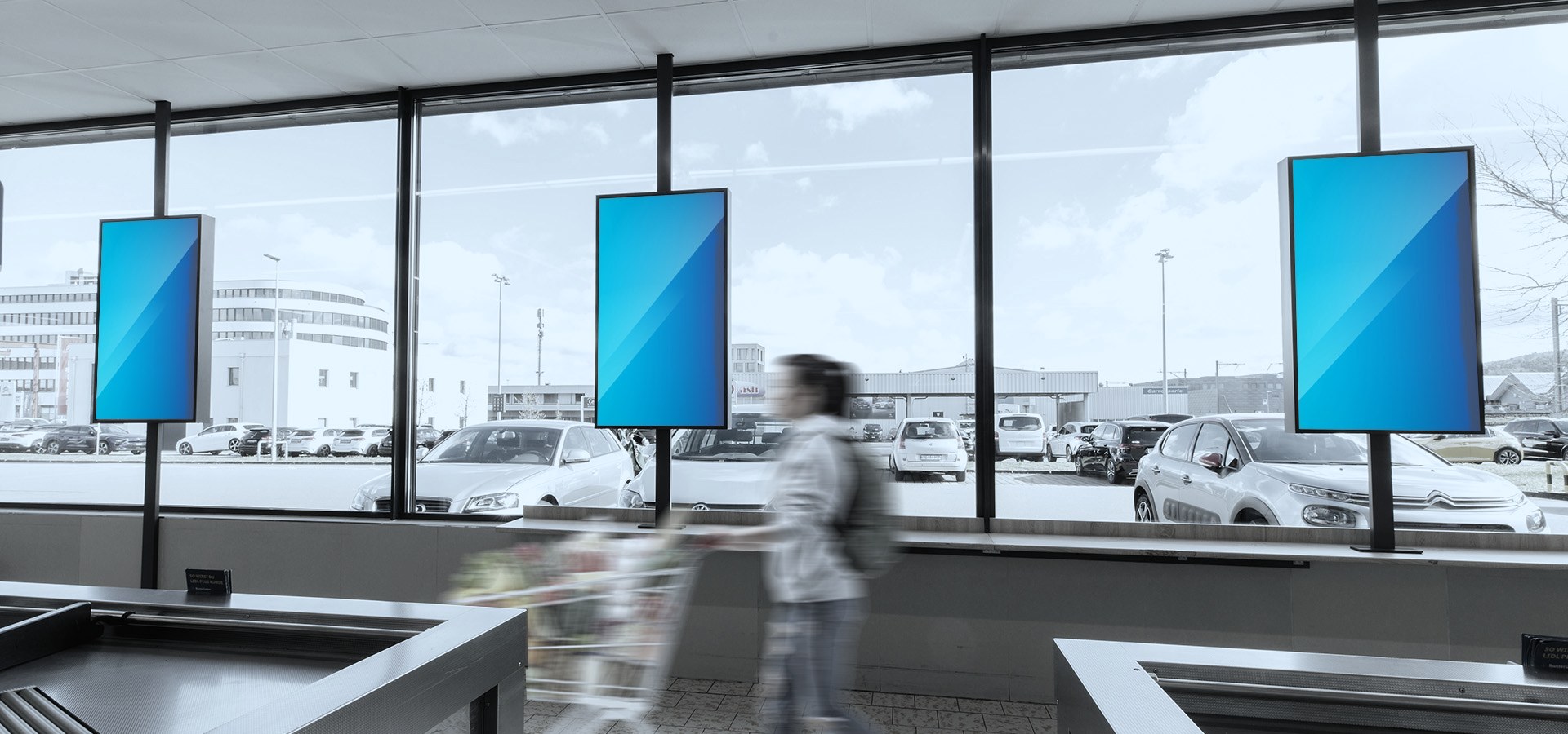 DOOH advertising screens in the till area of a Lidl store in Switzerland